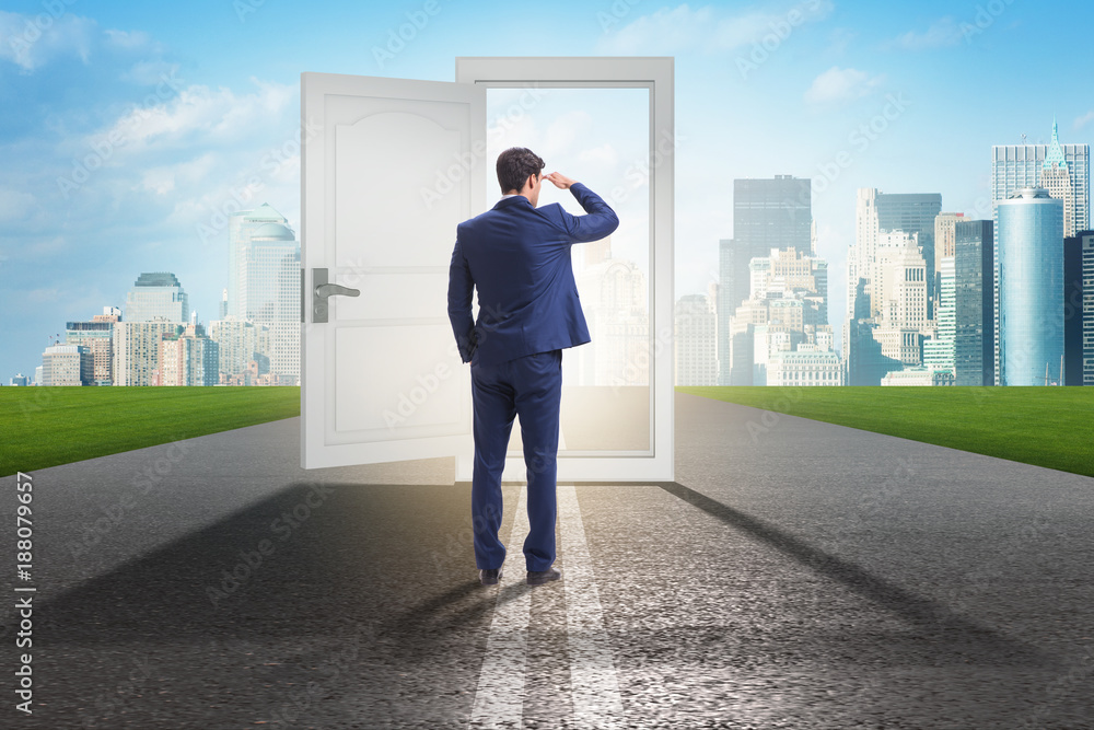 Businessman in front of door in business opportunities concept Businessman in front of door in business opportunities concept