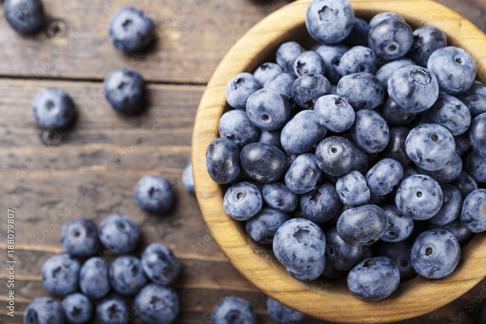 ripe organic bog whortleberry in a wooden plate on a wooden background ripe organic bog whortleberry in a wooden plate on a wooden background