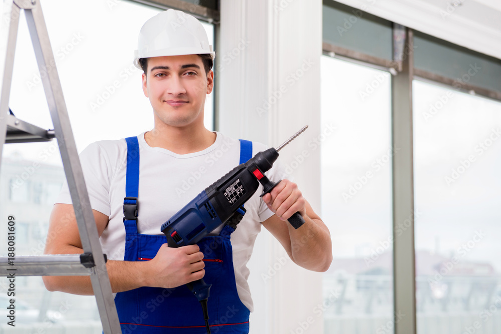 Repairman working with power drill in workshop