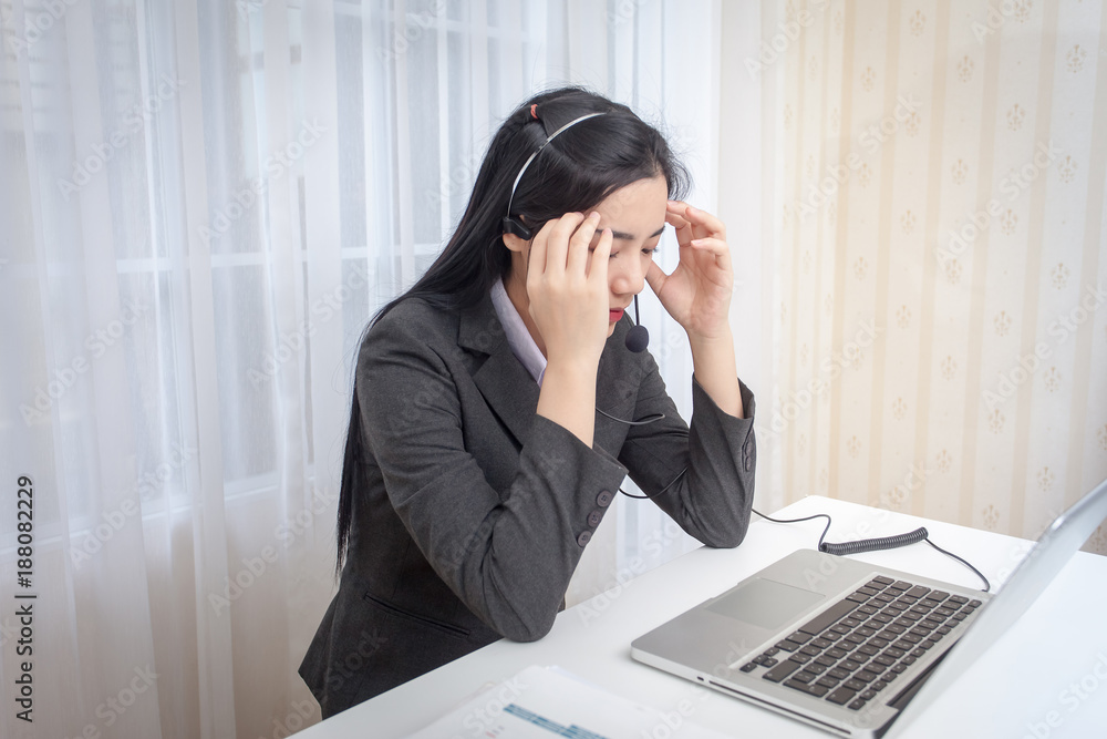 Call center operator. Feeling stress from work in the office Call center operator. Feeling stress from work in the office