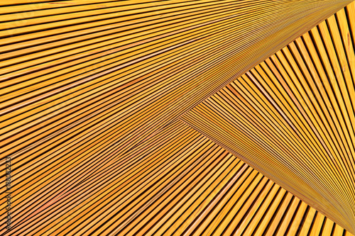 Abstract photo montage of yellow orange timber. Converging lines of planks.