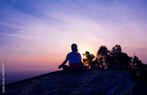 silhouette lady meditation on the hiltop at Tiger cave or Wat Tam Sua Krabi Thailand