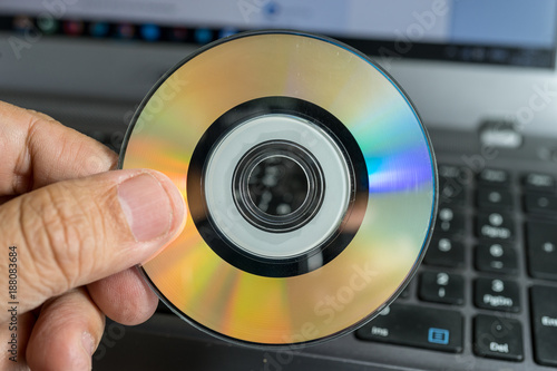 Hand holding Mini Gold Compact Disc