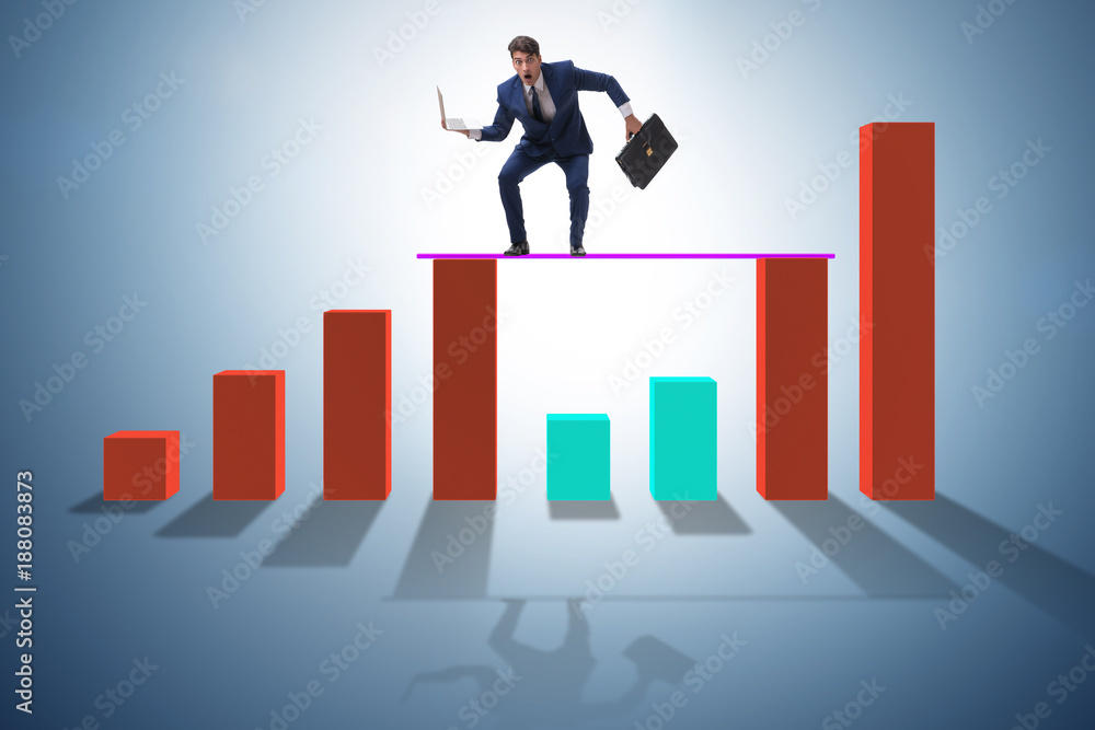 Young businessman in business concept with bar charts Young businessman in business concept with bar charts