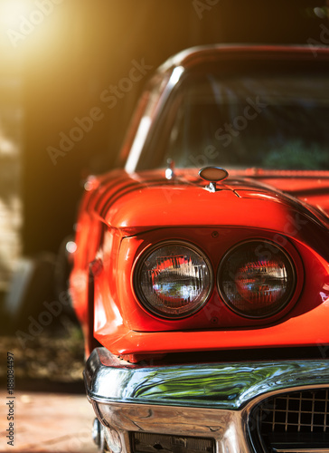 Headlight lamp of red vintage classic car © Success Media