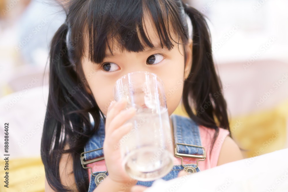asian children cute or kid girl thirsty and drinking cold water with ice in glass for healthy asian children cute or kid girl thirsty and drinking cold water with ice in glass for healthy