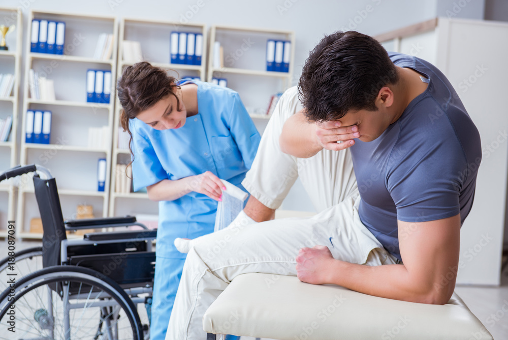 Doctor and patient during check-up for injury in hospital Doctor and patient during check-up for injury in hospital