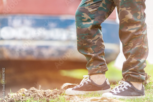 boy feet wearing long trousers and sneakers standing outdoor summer vacations lifestyle concept photo