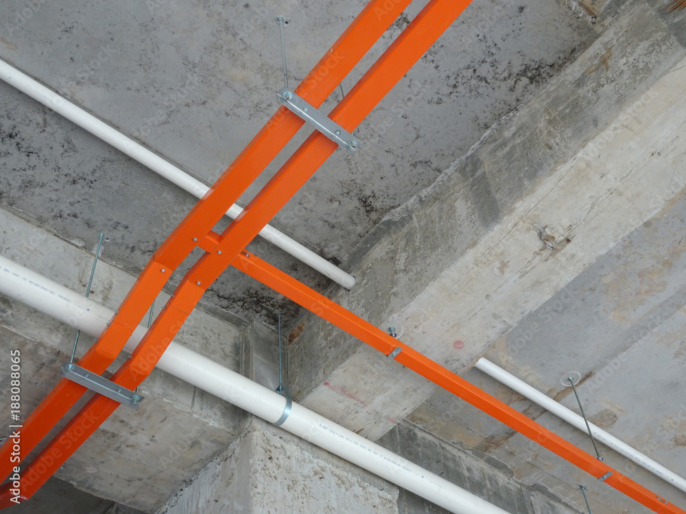 Electrical cable tray install hanging at the above floor soffit. Cable tray  install above ceiling level. Stock Photo