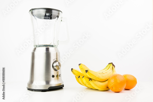 Metal Food Blender Closeup With Fresh Exotic Tropic Fruits Next To It On White Background With Empty Space