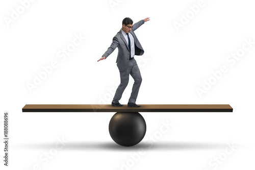 Konstfotografi Businessman balancing on seesaw in uncertainty concept