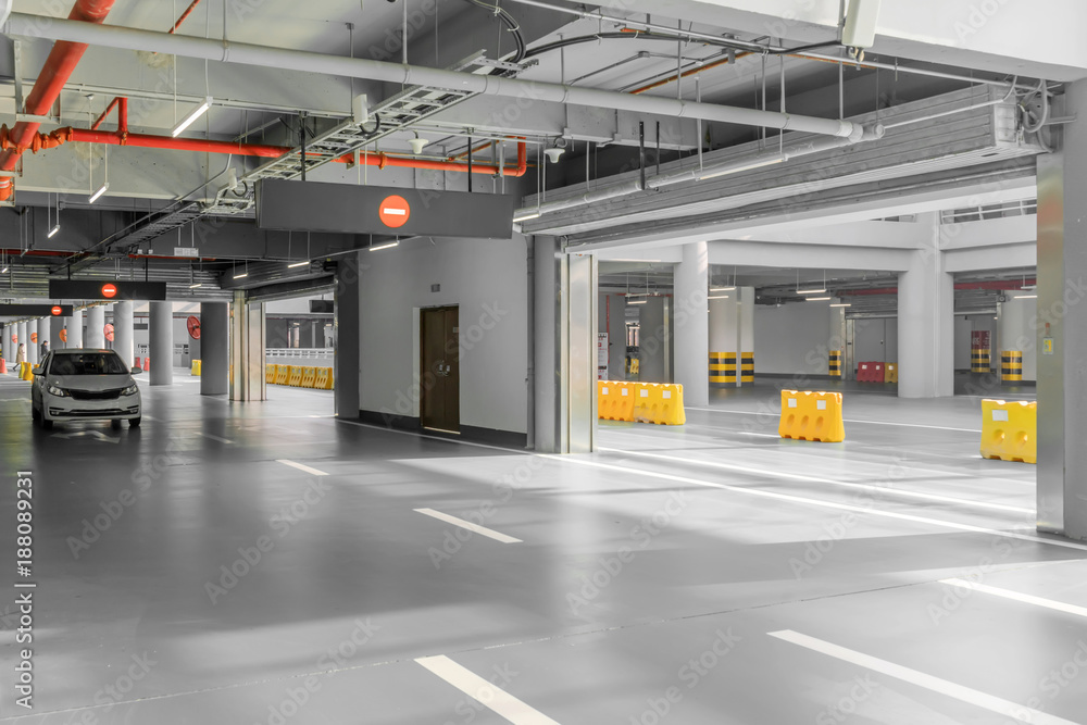 interior of parking garage with car and vacant parking lot in parking building interior of parking garage with car and vacant parking lot in parking building