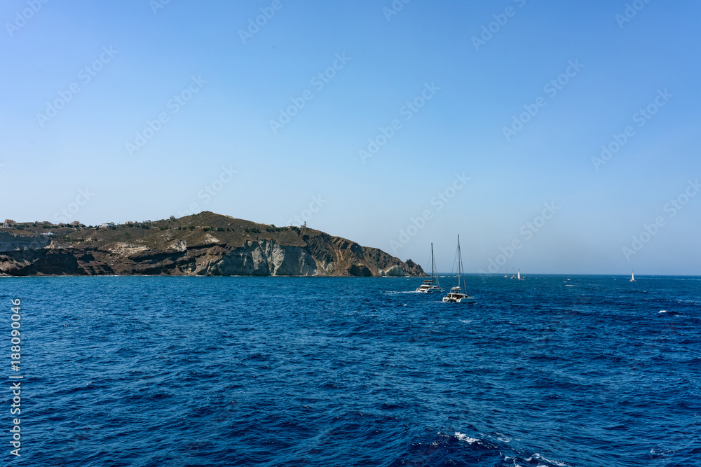 Boats with tourists near Santorini islands. Greece in summer.