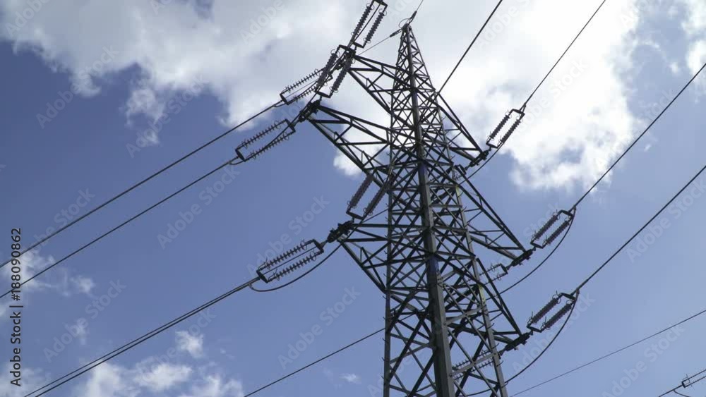 Power Transmission Line With Cloudy Sky On The Background.Electrical Transmission Tower And Power Lines.Time-lapse Clouds run over High-voltage transmission line Power Transmission Line With Cloudy Sky On The Background.Electrical Transmission Tower And Power Lines.Time-lapse Clouds run over High-voltage transmission line