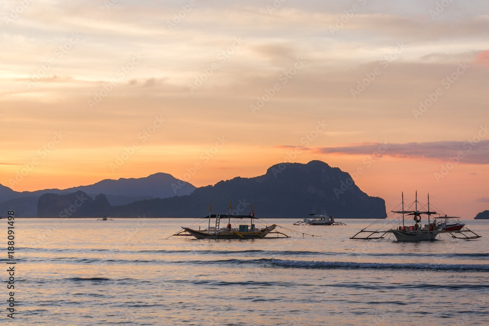 Bangka boats view at beautiful sunset on El Nido bay, Palawan island, Philippines