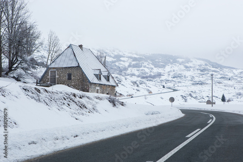 Mountain winter road goes through the village