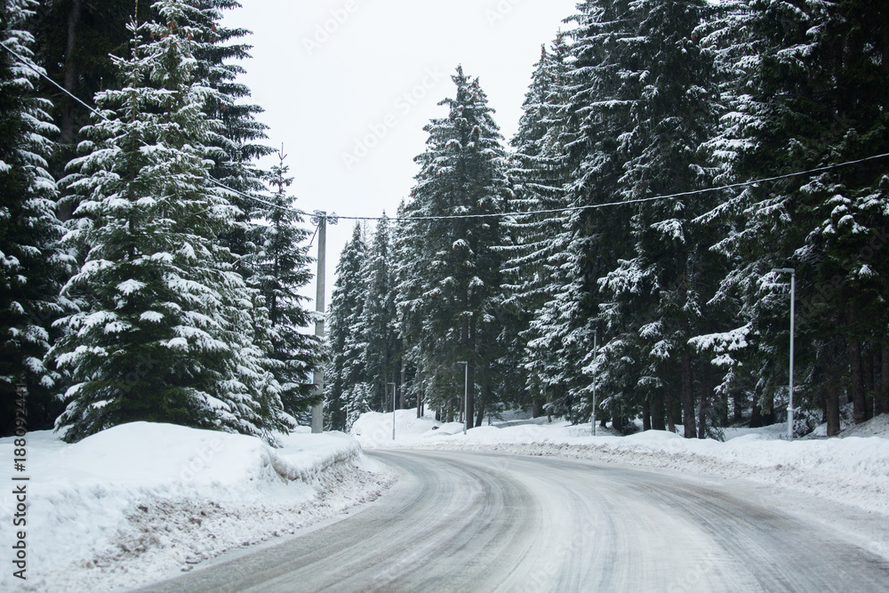Mountain winter road through the forest Mountain winter road through the forest