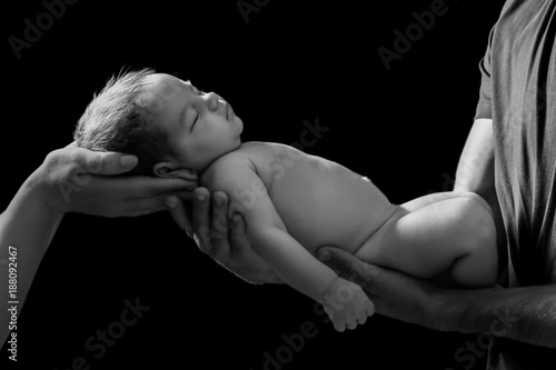 Hands of parents holding cu...