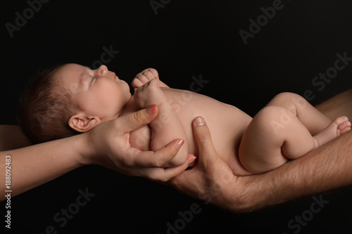 Hands of parents holding cu...