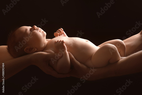 Hands of parents holding cu...