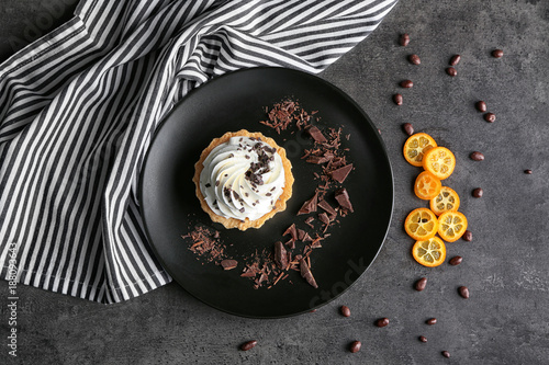 Plate with tasty tartlet on table