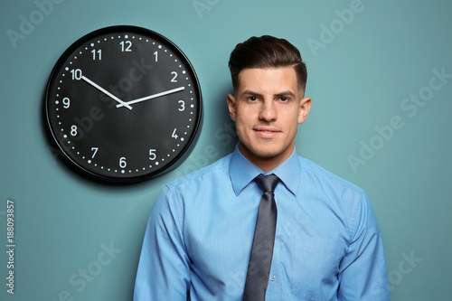 Handsome manager near wall ...