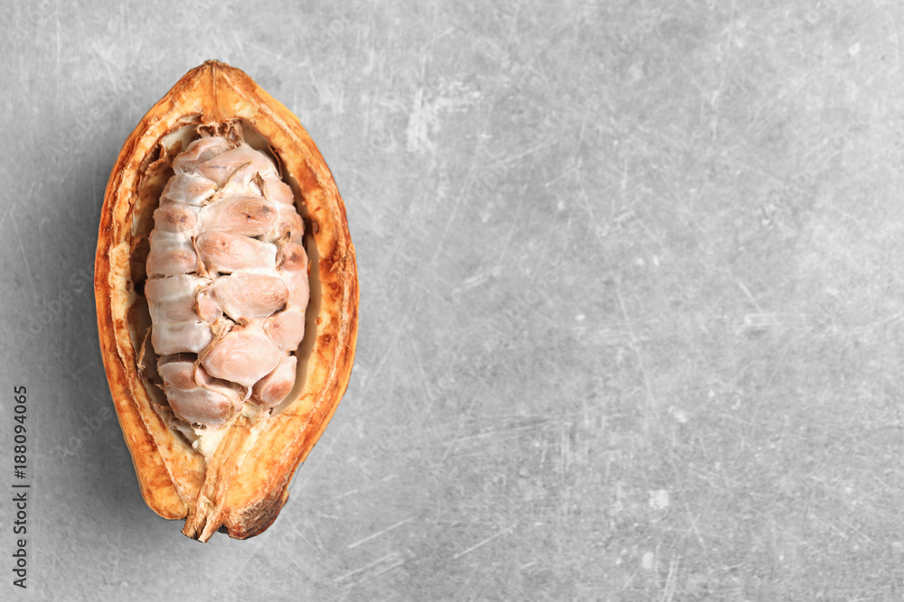 Naklejka premium Cut cocoa pod on grey background