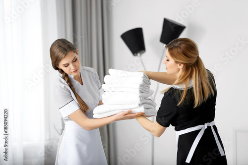 Chambermaid in uniform teac...