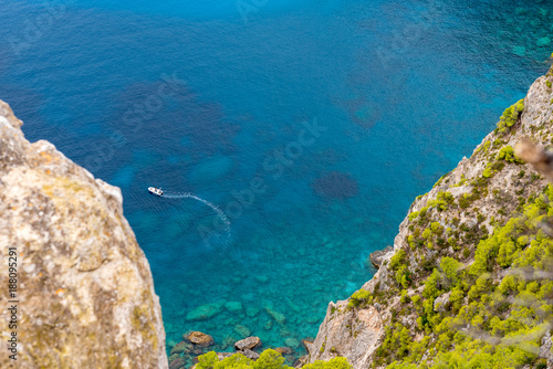 Keri cape. Blue water, boat and rocks of beach on Zakynthos island, Greece