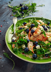 Fresh Chicken salad with Blueberries, feta, carrots, nuts and green vegetables. healthy food concept
