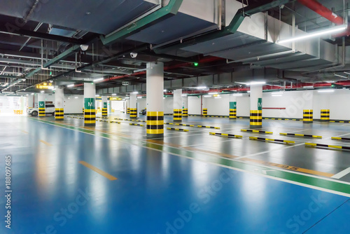 interior of parking garage with car and vacant parking lot in parking building