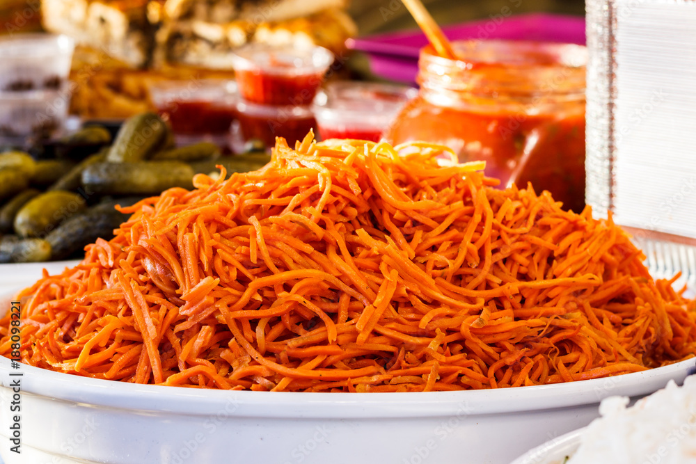 Orange marinated carrots on a large white plate. close-up. Orange marinated carrots on a large white plate. close-up.