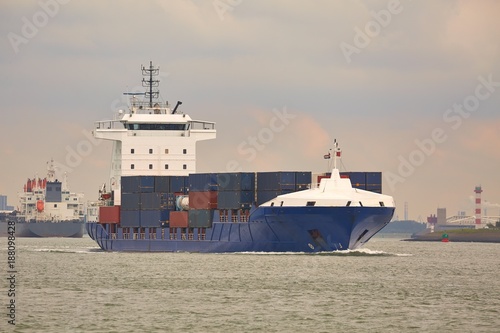 Ship carrying containers through Rotterdam