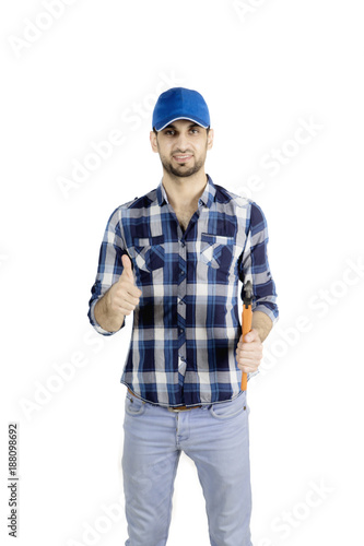 Young plumber with thumb up and wrench © Creativa Images
