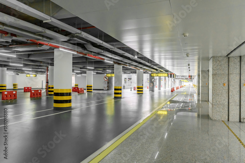 interior of parking garage with car and vacant parking lot in parking building
