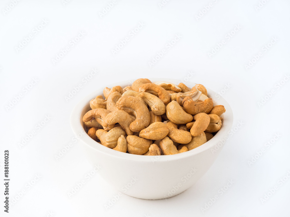 white bowl with a handful of nuts of cashew on white background table white bowl with a handful of nuts of cashew on white background table