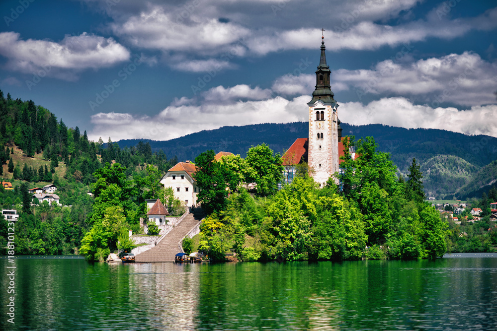 Bled lake with church island and mountains in background. Bled lake with church island and mountains in background.