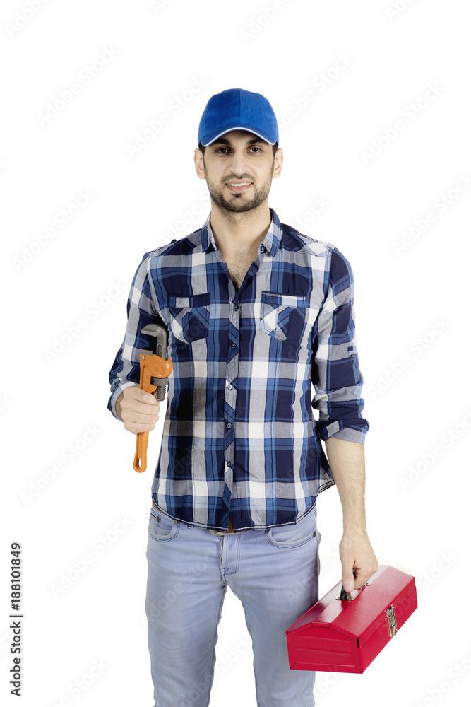 Male plumber carrying tool box on studio Male plumber carrying tool box on studio