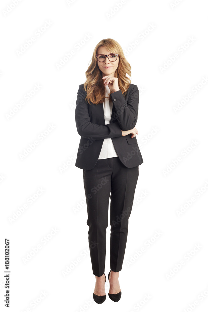 Full length portrait of an attractive mature businesswoman standing against white background. Studio shot. Full length portrait of an attractive mature businesswoman standing against white background. Studio shot.