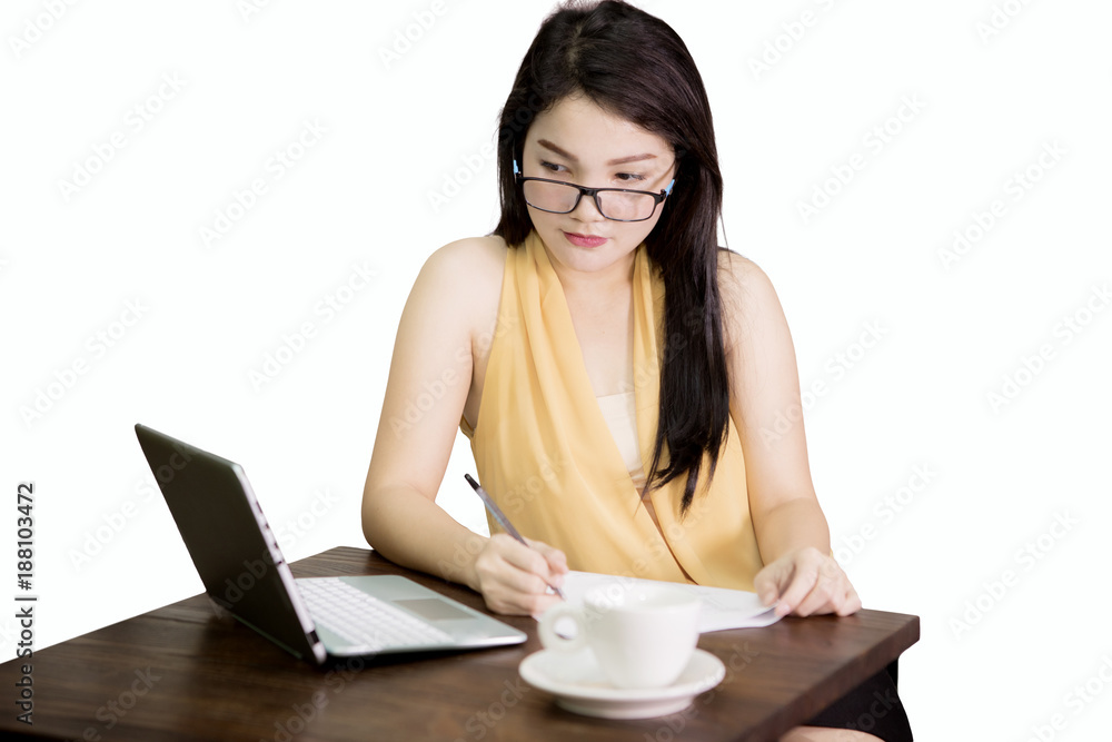 Female entrepreneur with paperwork and laptop Female entrepreneur with paperwork and laptop