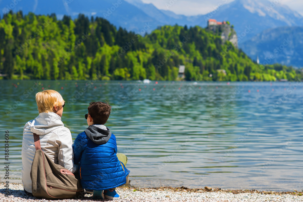 Mother and son resting by the lake Mother and son resting by the lake