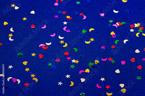 Blue sparkling and glitter background witl little hearts, stars and moons. Top view. photo