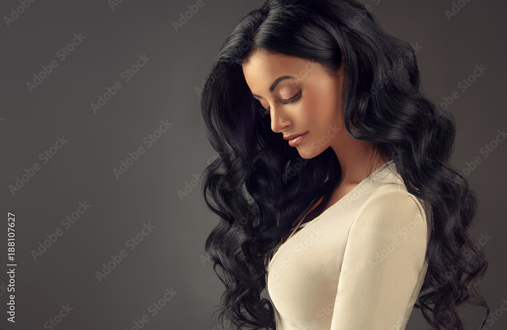 Brunette girl with long and shiny wavy hair . Beautiful model woman with  curly hairstyle . Stock Photo | Adobe Stock