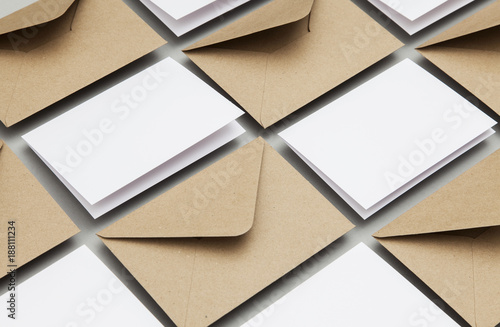 Photos Blank white card with kraft brown paper envelope template mock up