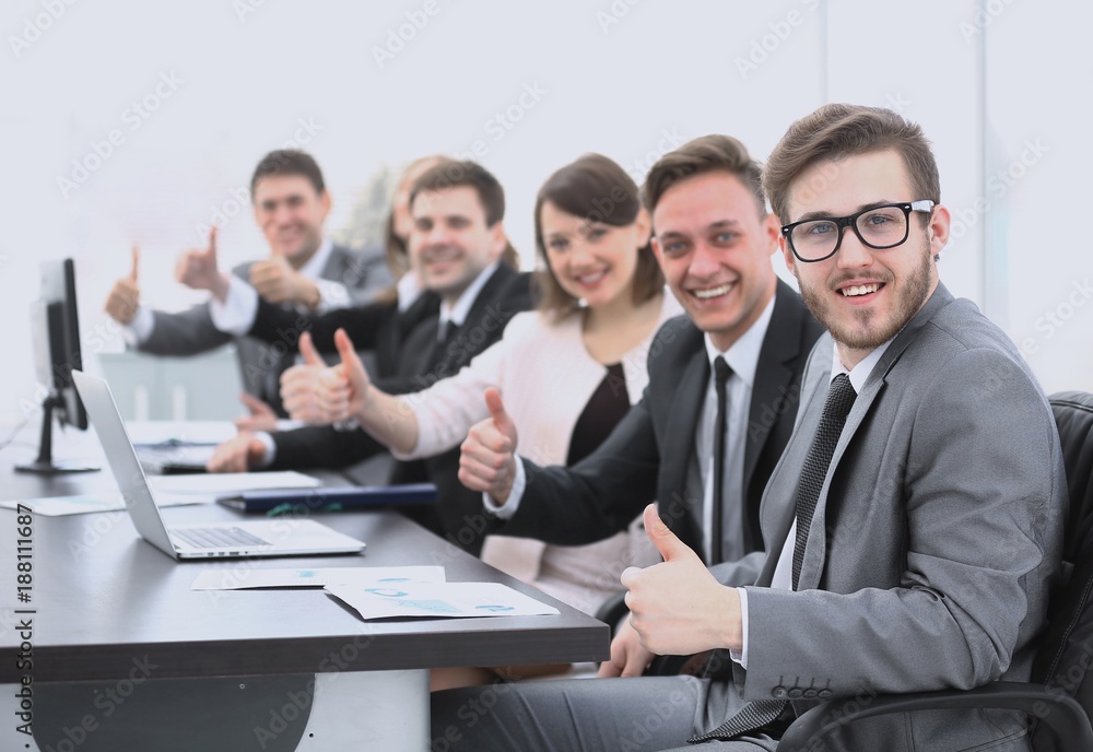 business team with thumbs up while sitting at his Desk business team with thumbs up while sitting at his Desk