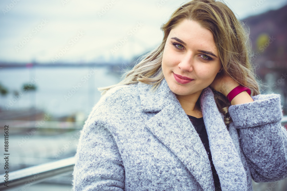 Stylish plump young woman expresses elegants, walks outdoors against the backdrop of the city, XL model lifestyle portrait of beautiful stylish young girl in the city. Wearing wool coat Stylish plump young woman expresses elegants, walks outdoors against the backdrop of the city, XL model lifestyle portrait of beautiful stylish young girl in the city. Wearing wool coat