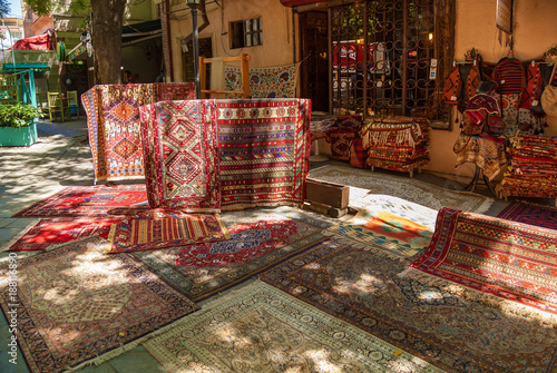 Old beautiful decorated carpets in the street market in Tbilisi. Carpets on the street market in Tbilisi.