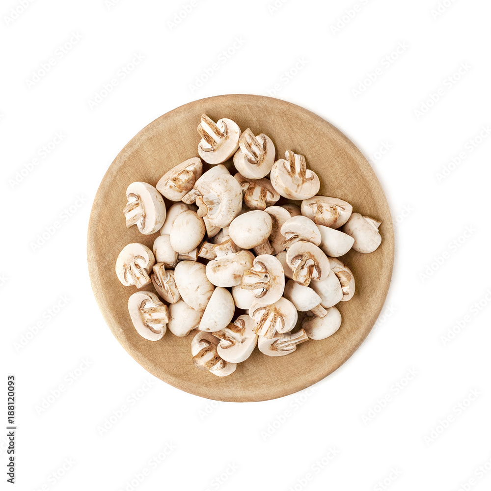 Cut mini champignons on a round wooden cutting board. Isolated over white background.. Cut mini champignons on a round wooden cutting board. Isolated over white background..