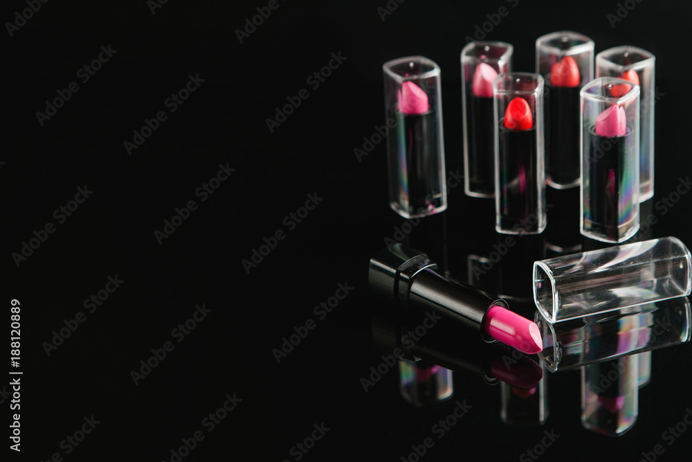 wide selection of women's lipsticks on black background. beauty blog. professional make-up courses. free space concept wide selection of women's lipsticks on black background. beauty blog. professional make-up courses. free space concept