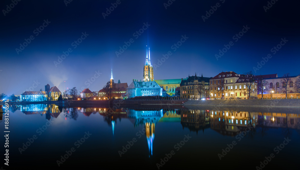 Panoramic view of famous old island Tumski with cathedral of St. John reflection in the Odra river at dusk. Wroclaw, Poland, EU. A long time shutter exposure.